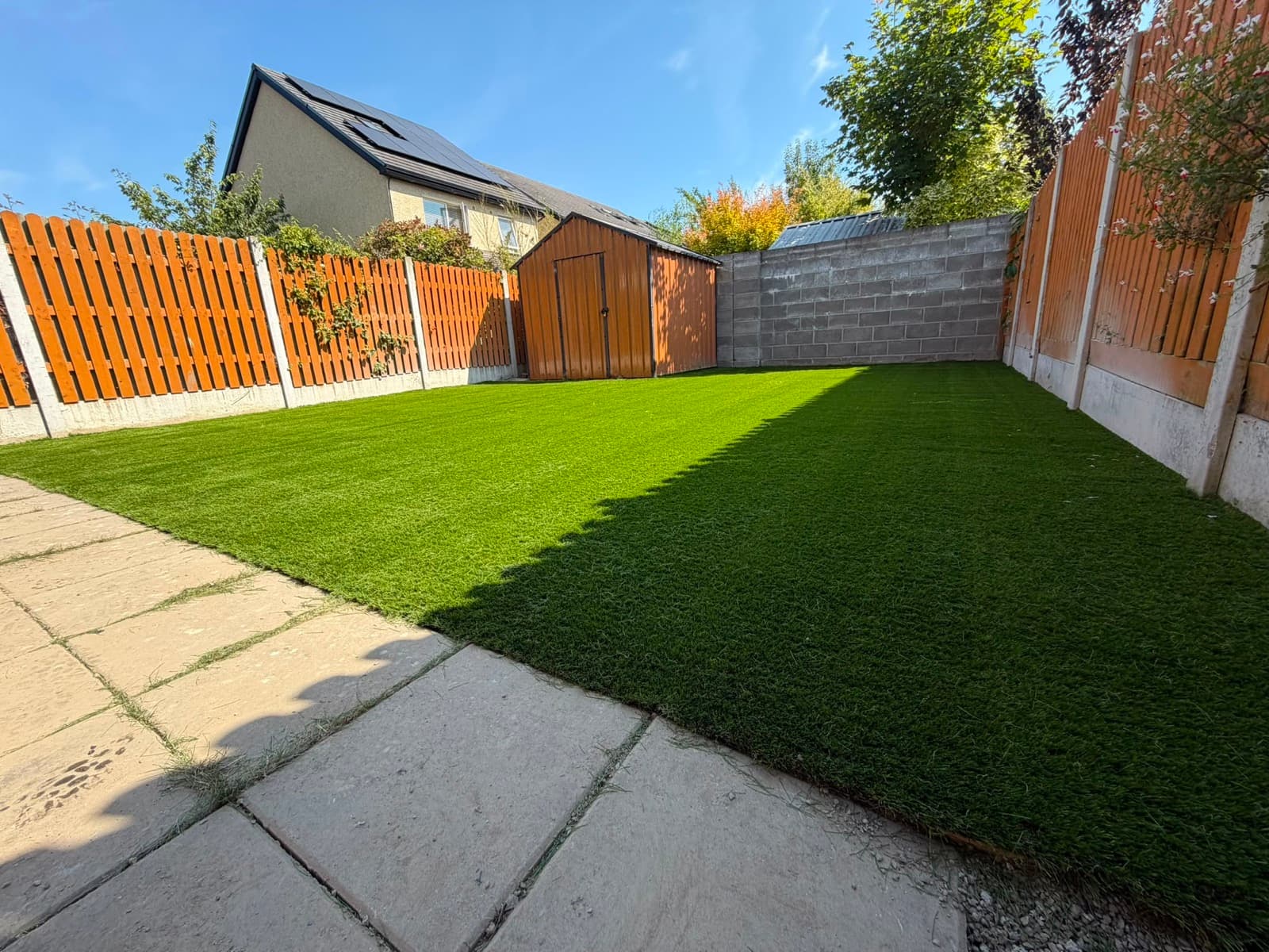 Neat artificial lawn edge against paving